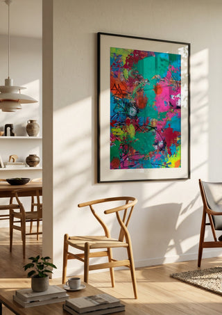 paint it loud by hazelart in a black frame in a bright dining room with wooden chairs