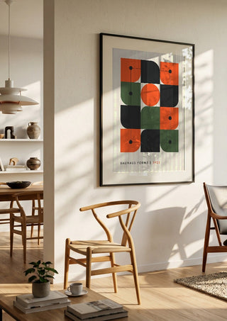 Bauhaus Forms 1923 by Neil Stevens in a black frame in a bright dining room with wooden chairs