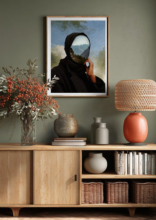 The Mountain Within by Fran Rodriguez above a wooden sideboard on a sage green wall