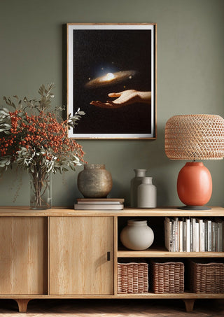 Supernova by Fran Rodriguez above a wooden sideboard on a sage green wall
