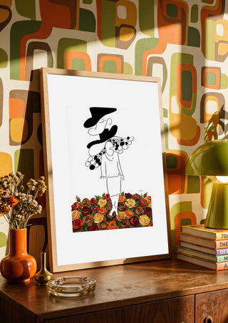 The weight of the world by Madame Petit in a wooden frame on a sideboard against a retro patterned wall