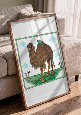 The Camel and the Book by Waldemar Mandzel in a walnut frame leaning against a grey sofa