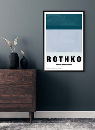 Framed Rothko Interstellar art print on a grey wall above a wooden dresser with vase and dried plants.