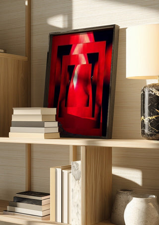 Corazon by Carlos Enrique Gozalo Ara in a dark frame on a wooden shelf beside books and a lamp