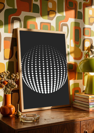Bubbles by Aleksi Allan in a wooden frame on a sideboard against a retro patterned wall