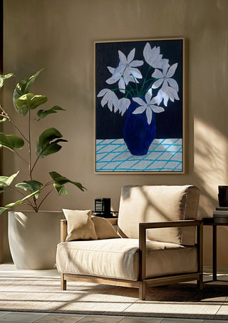 Blå blomster på rutig duk by Rebecka Hansson framed above a beige armchair beside a potted plant