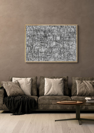 Mobility in Sight by Priit Ruttas in a pale wooden frame above a grey sofa with cushions