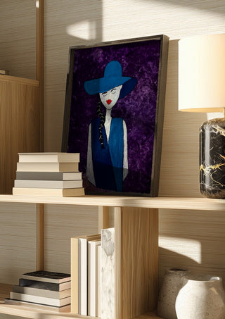 The Midnight Silhouette by Bibi in a dark frame on a wooden shelf beside books and a lamp