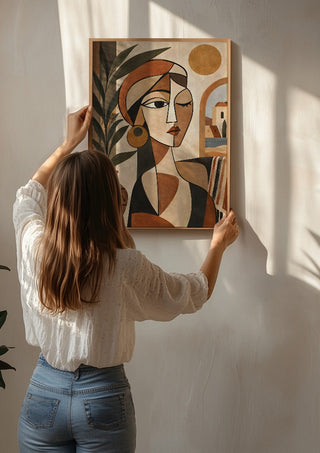Mediterranean Cubist Woman by TimlessArtworks being hung on a sunlit wall
