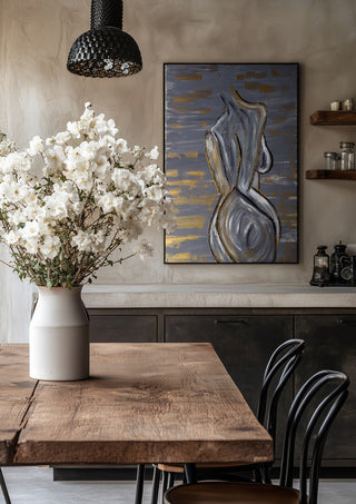 Contours of Silence by Bibi in a black frame above a rustic table with white flowers