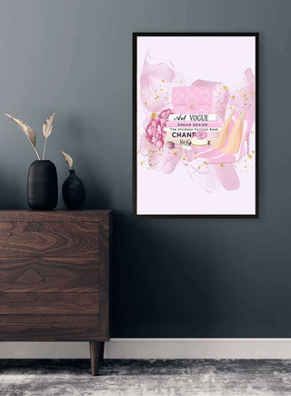 Framed wall art with pink watercolor, flowers, and fashion-themed text, styled above a wooden dresser.
