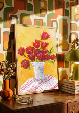 Tulips - II by Deblina Dey in a wooden frame on a sideboard against retro patterned wallpaper
