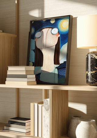 Reklamation Sternenhimmel by lacaluna in a dark frame on a wooden shelf beside books and a lamp