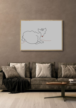 Resting Cat by Eva Hartman in an oak frame above a grey sofa with cushions