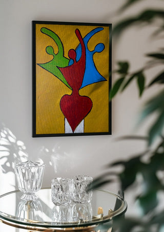 The Synthesis of Sel by Bibi in a black frame above a glass table with crystal glassware