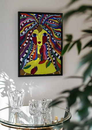 Kaleidoscopic Minds by Bibi in a black frame above a glass table with crystal glassware