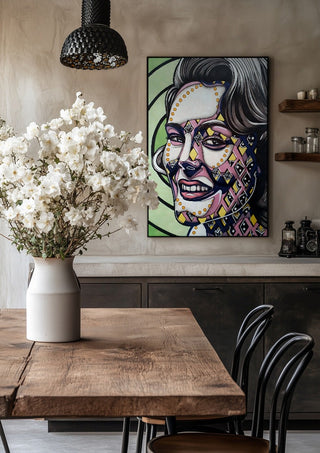 Vertigo by Okiana in a black frame above a rustic table with white flowers