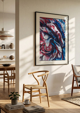 Rose by Okiana in a black frame in a bright dining room with wooden chairs