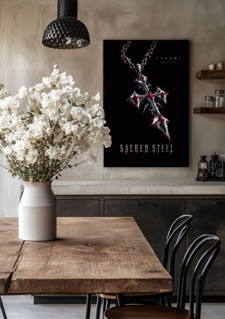 Sacred Steel by Melancholy Machinations in a black frame above a rustic table with white flowers