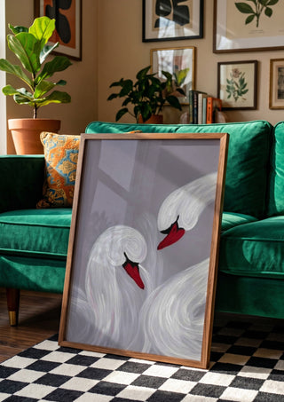 The Swirl of Us by Bibi in a wooden frame beside a green velvet sofa on a chequered floor
