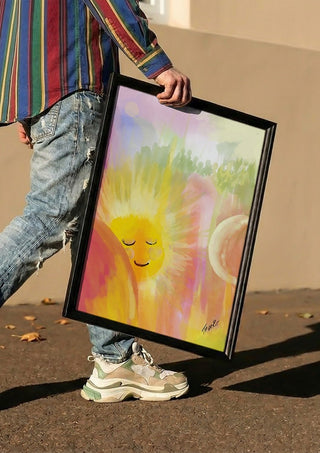 Let the sunshine in by FridaRit carried in a black frame along a sunny street