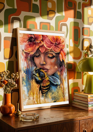 BeeYou by Elisa Kay leaning on a wooden sideboard against retro patterned wallpaper