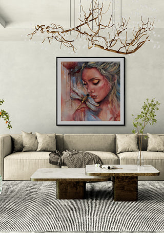 Inner Reflection by Elisa Kay framed above a long sofa under a branch chandelier