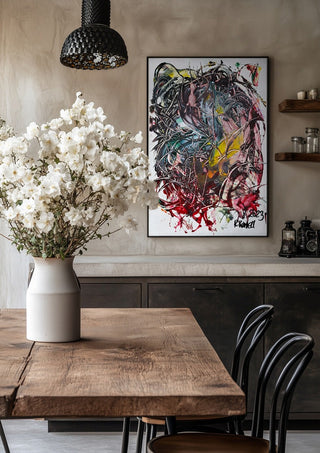 Tangle by Ronald Rumell in a black frame above a rustic table with white flowers