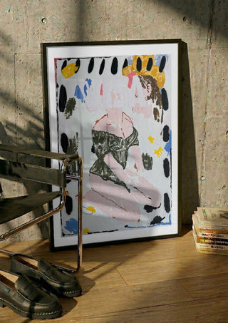 VISA OWNS MY EYES by Oscar Birch in a black frame leaning against a concrete wall by a steel chair