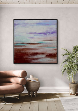 Lavender Haze by Marina Agre in a black frame above a pink armchair beside a palm