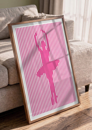 Ballerina silhouette by nyai in a walnut frame leaning against a grey sofa