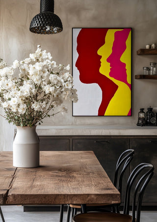 Genesis by Tonia in a black frame above a rustic table with white flowers