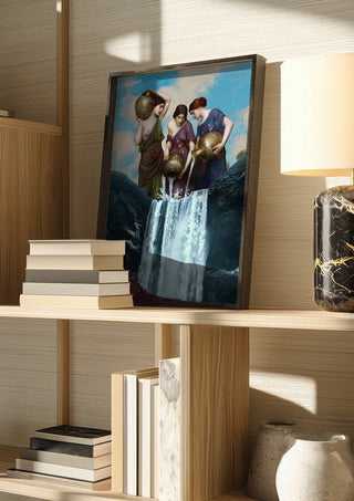 Magic Waterfall by Dikhotomy in a dark frame on a wooden shelf beside books and a lamp