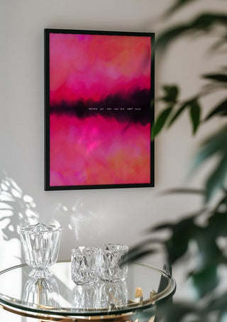 Never let them know your next move by Astrid Lind in a black frame above a glass table with crystal glassware