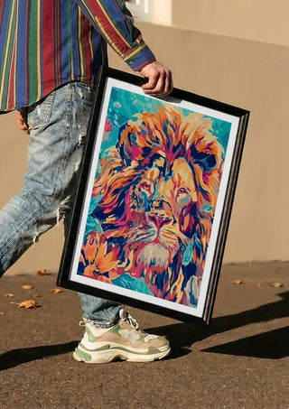 The Geometric King by Bibi carried in a black frame along a sunny street
