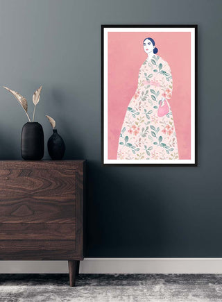 Framed "He Loves You" by Elara Monet featuring a woman in a floral dress, displayed above a dresser.