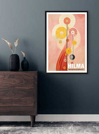 Framed Hilma No 02 - Tara Green abstract art print displayed on a dark wall above a wooden dresser with decor.
