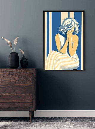 Framed Blues Dress No 02 by David Wolf displayed above a wooden sideboard in a modern room.
