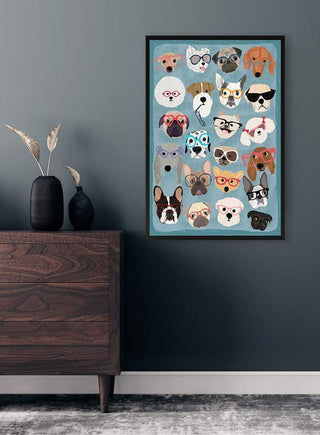 Framed puzzle featuring illustrated dogs wearing various styles of glasses, displayed on a dark wall above a dresser.