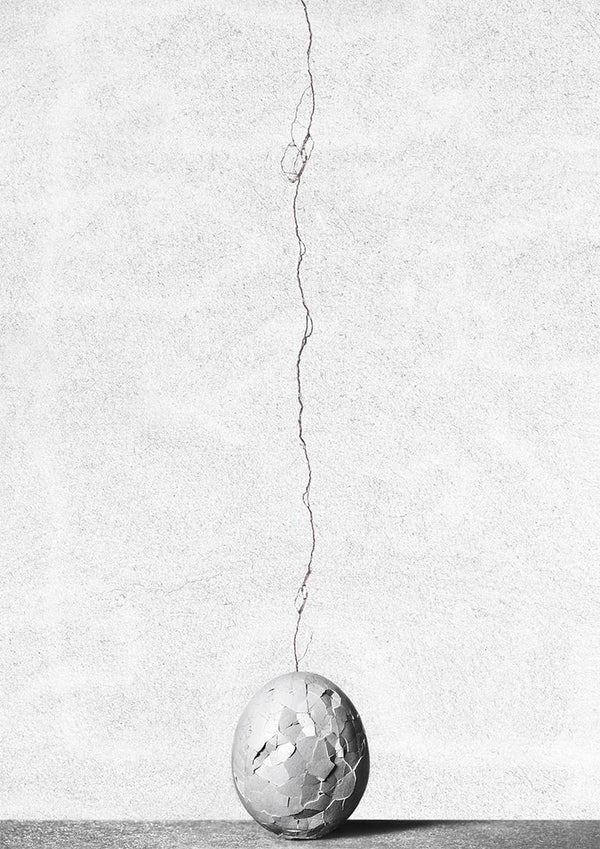 A cracked sphere with a wire extending upward, featured on the Cracks by Giorgio Toniolo product page.