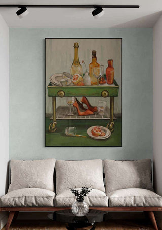 Framed "Afterparty" by Martina Karlsson featuring drinks, high heels, and glasses above a modern couch.