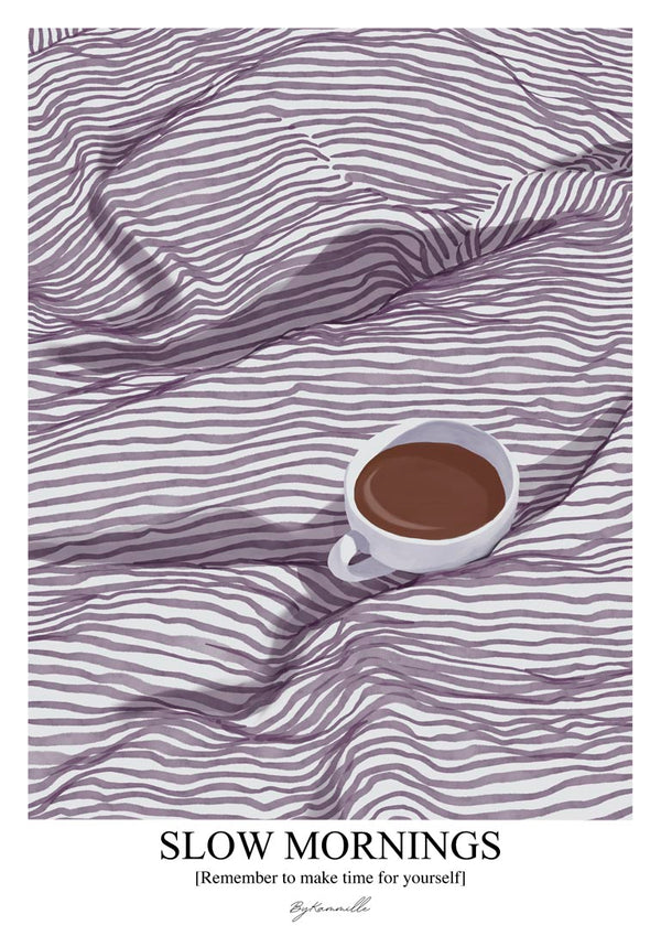 A cup of coffee on a striped bedspread, with "Slow Mornings" and ByKammille branding below.