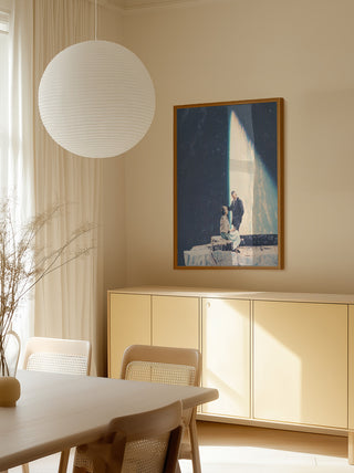 Framed "This Love" by Frank Moth hanging above a light wood sideboard in a sunlit dining room.