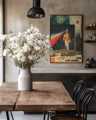 Poster "You Can Make It Right" by Frank Moth displayed above a rustic dining table with white flowers in a vase.