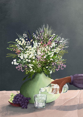 A vase of wildflowers beside grapes as water is poured into a glass, featured on Frivolous Afternoon - Goed Blauw.
