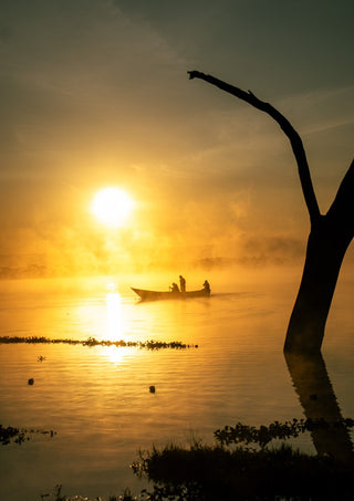 Fishermen Of Naivasha by Gloria Mwivanda - fishermen silhouetted in a canoe at sunrise