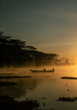 Fishermen on Naivasha. (two) by Gloria Mwivanda - two fishermen in a canoe on a misty lake at sunrise