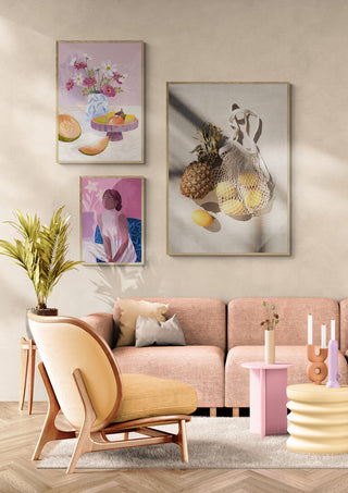 Modern living room with summer fruit-themed artwork, featuring pineapples, melons, and fresh floral decor.