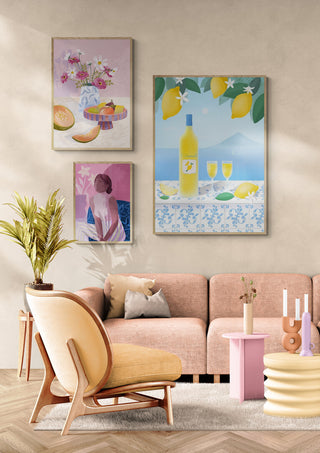 Framed art of a Limoncello bottle with glasses and lemons hanging above, displayed in a modern living room.