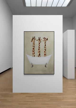 Art print of three giraffes in a white bathtub by Coco de Paris displayed on a gallery wall.
